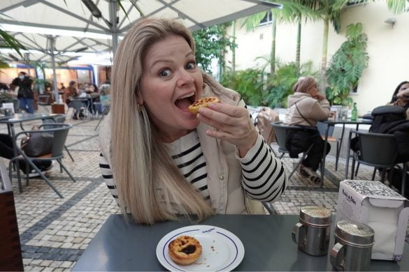 Melissa of Tourabunga enjoys a pastel de nata from Pastiche de Belém, a famous bakery in Lisbon, Portugal.
