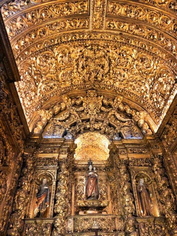 The gilded altarpieces inside the chapels of Igreja de São Roque, showcasing the intricate details of the Baroque architecture.