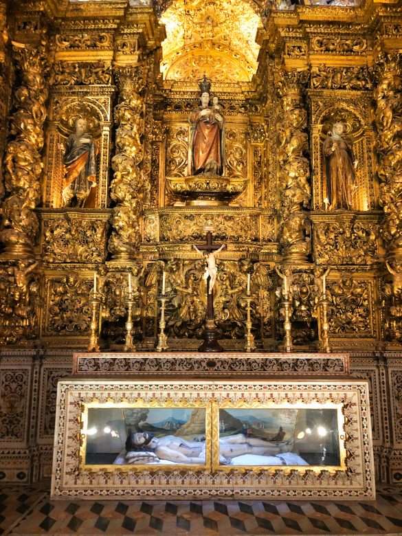 The chapels of Igreja de São Roque with warm light filtering through the stained-glass windows.