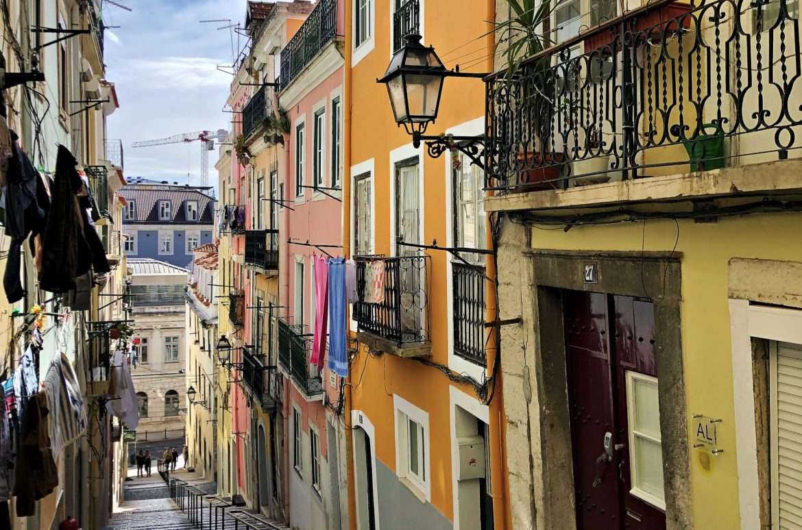 Lively neighborhood of Bica in Lisbon, Portugal - Iconic stairs, hanging clothes, and gritty charm