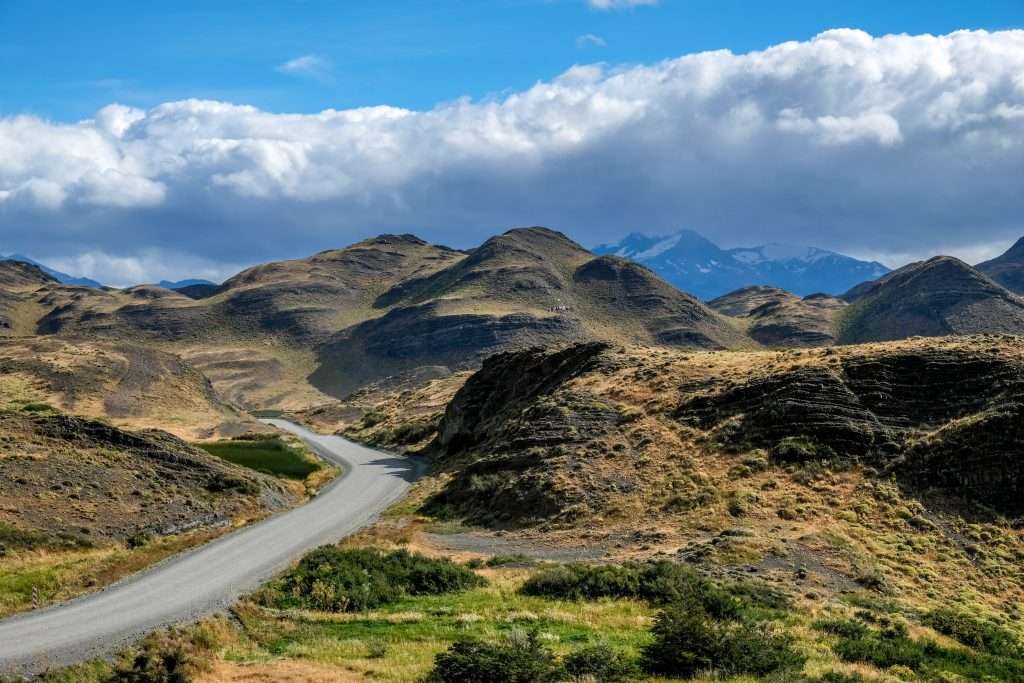 A scenic path through Torres del Paine National Park, inviting exploration of the road less traveled.